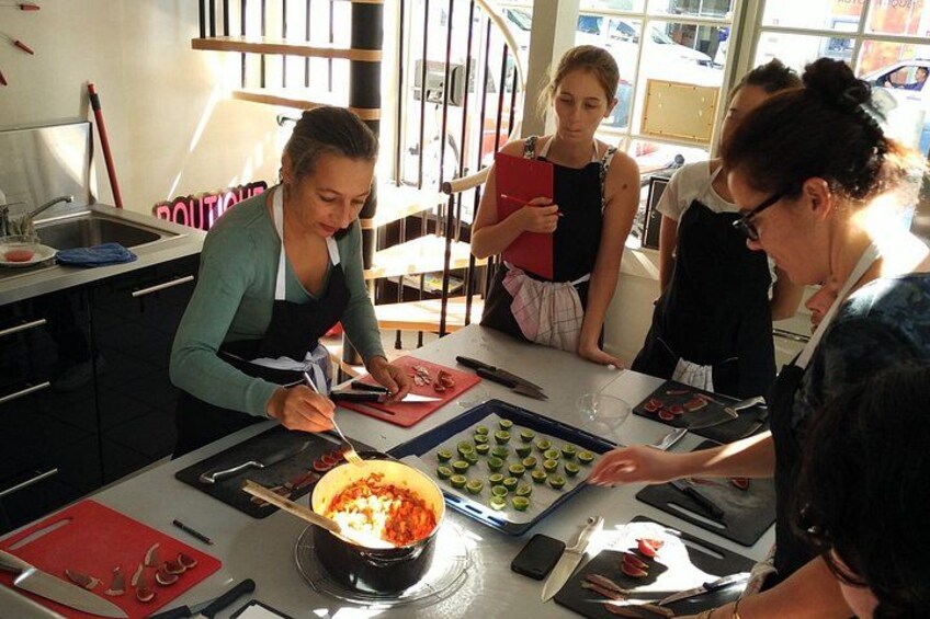 A group of people preparing food in a kitchen. 1