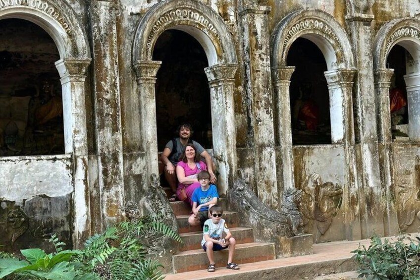A weathered building with arched doorways and steps leading up to it. 3