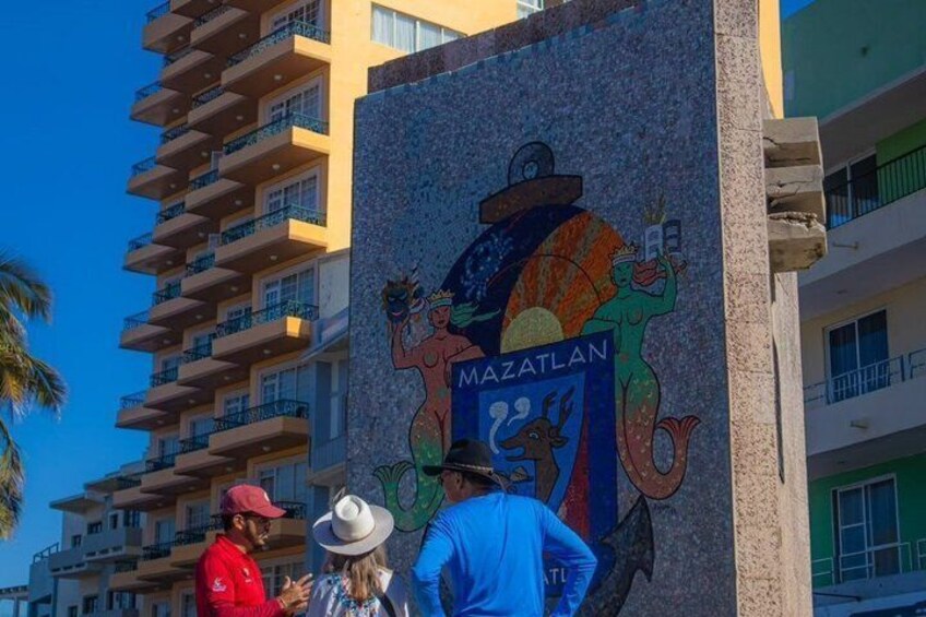 A colorful mural with the word 'MAZATLAN' and a coat of arms. 3