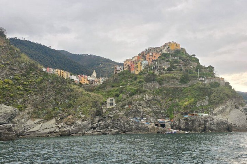 A coastal village with colorful buildings perched on a hillside. 2