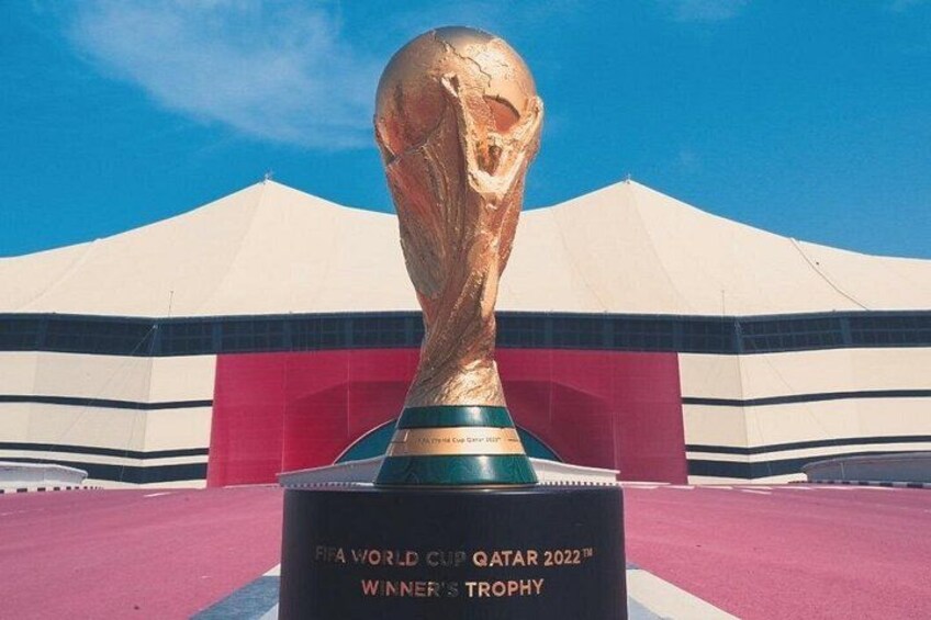 A golden trophy with inscriptions, placed on a pedestal. 5
