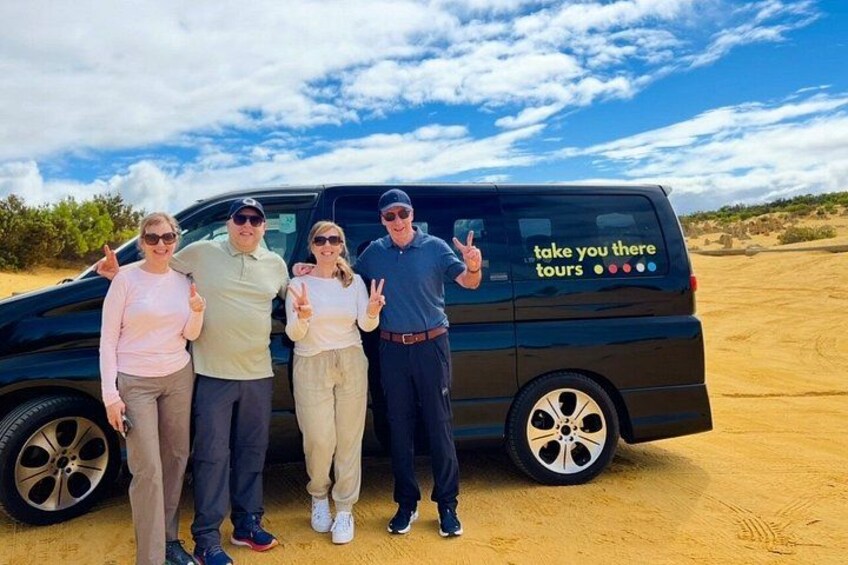 A group of people standing in front of a van with the text 'take you there tours' on its side. 3