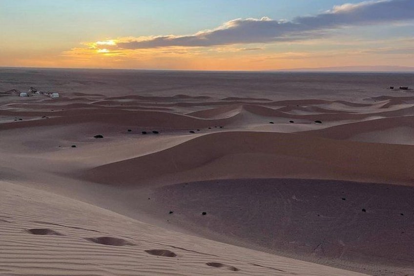 A desert landscape with sand dunes and a sunset. 5