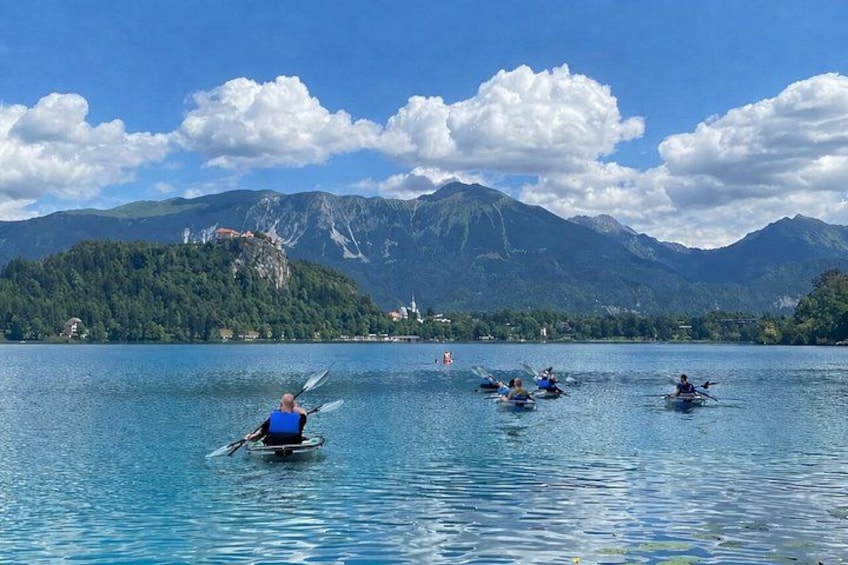 People kayaking on a lake with mountains in the background. 3