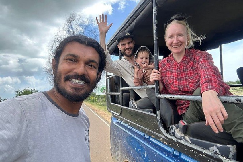 A group of people on a vehicle with a blue and white exterior, a road, and a cloudy sky. 3