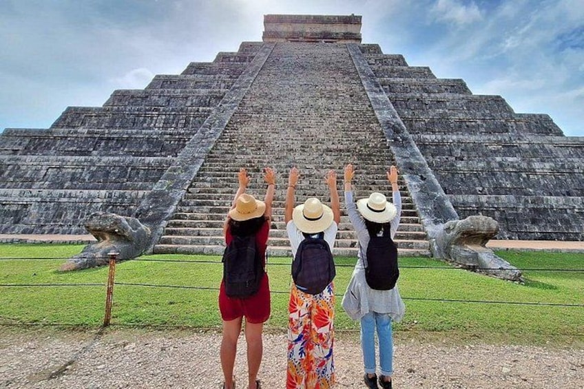 A large pyramid with tourists taking photos. 5