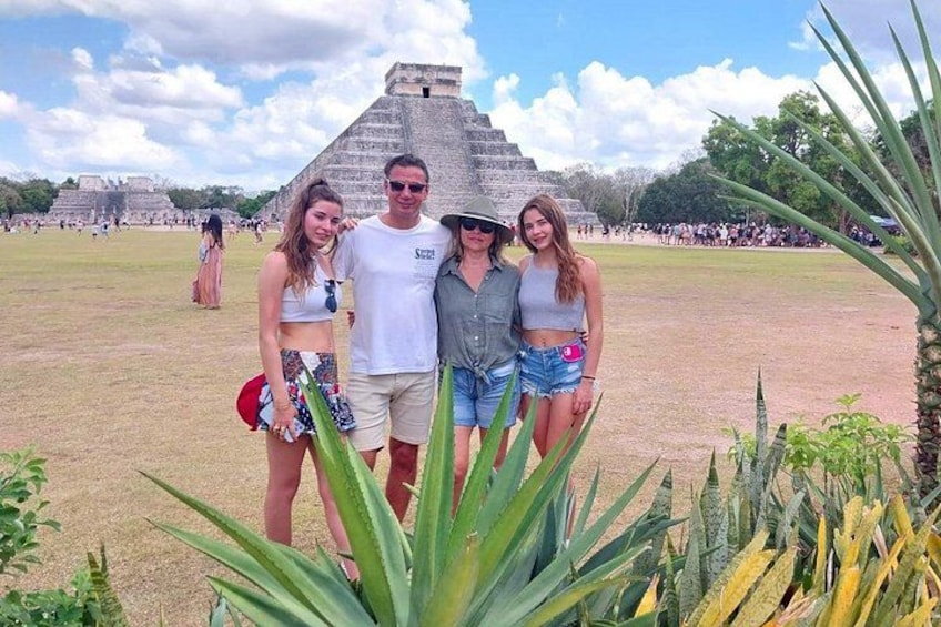 A pyramid, people, and a field with plants. 3