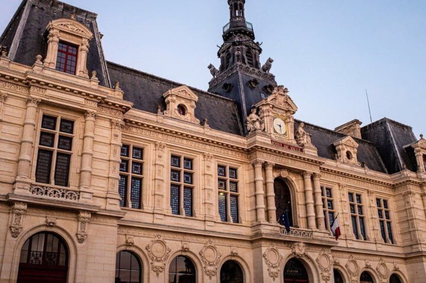 A historic building with ornate architecture, including a clock tower and arched windows. 4