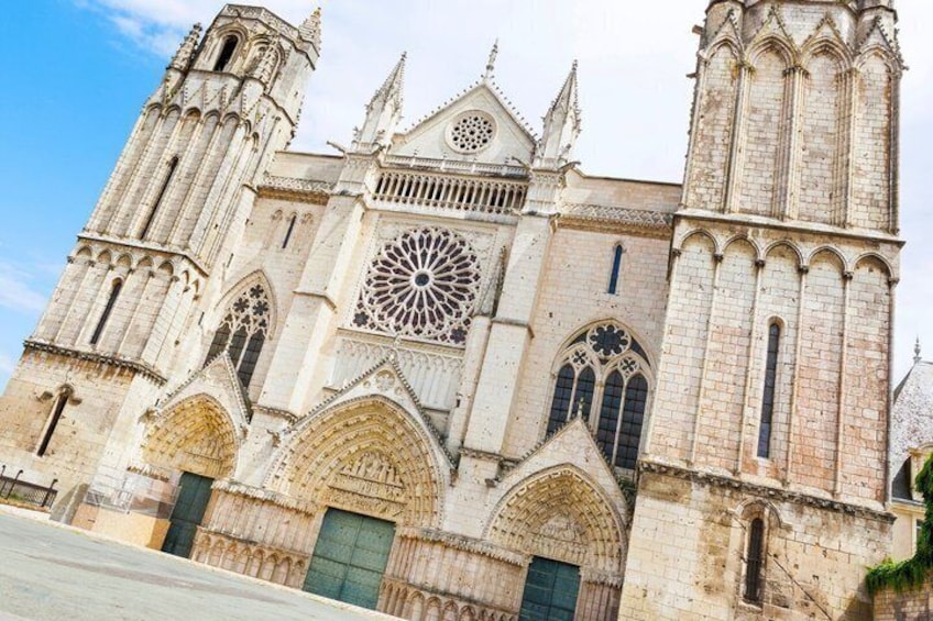 A historic cathedral with a large rose window, pointed arches, and twin towers. 3