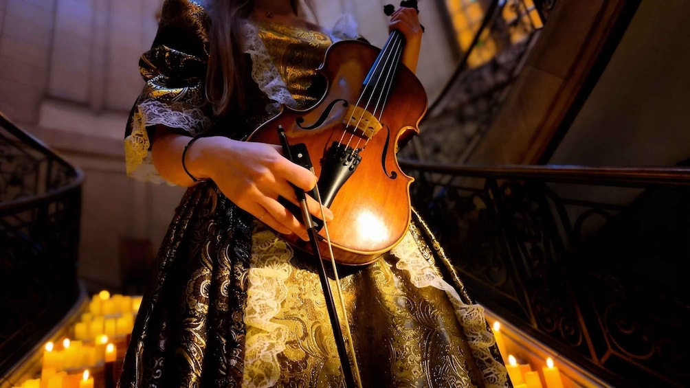 A person playing a violin. 3