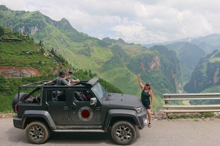 A black SUV on a road with a mountainous landscape in the background. 3