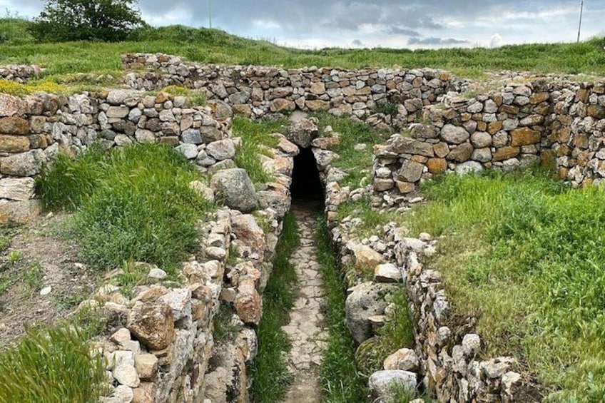 A stone archway leading into a narrow passage. 4