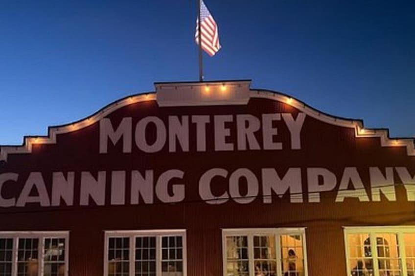 A building with the sign 'MONTEREY CANNING COMPANY' and an American flag. 1