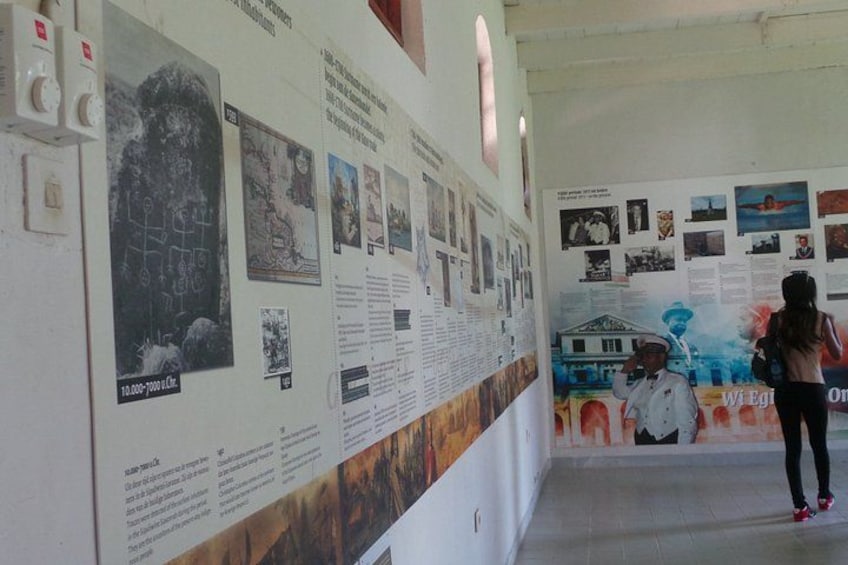A hallway with informational posters and a mural. 4