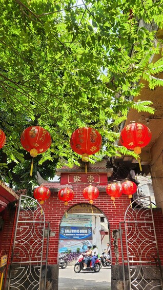 A traditional gate with red lanterns and a signboard. 2