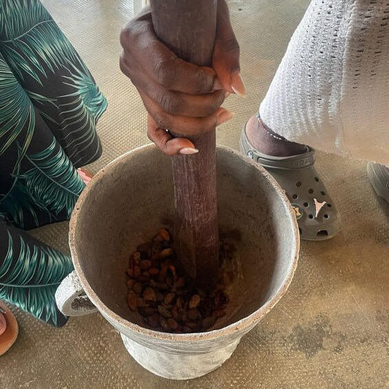 A person using a mortar and pestle to grind spices. 3