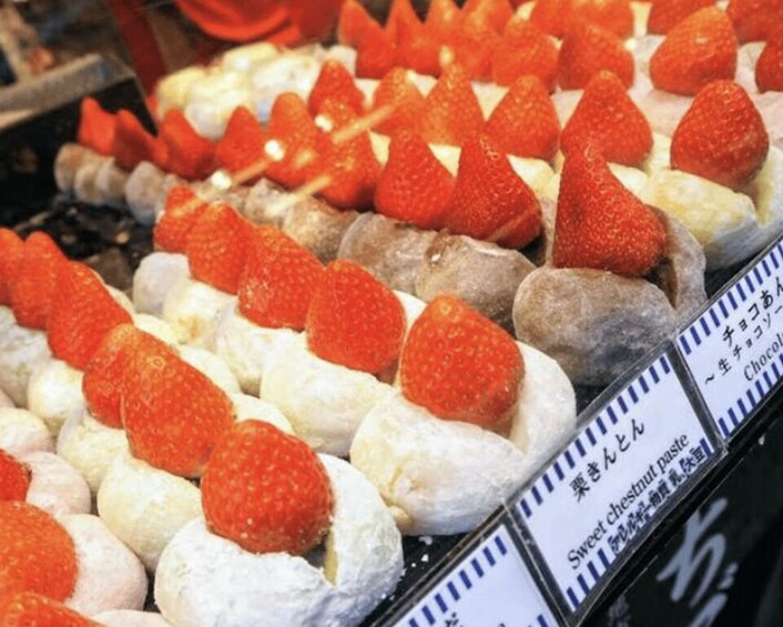 A display of pastries with strawberries on top. 2