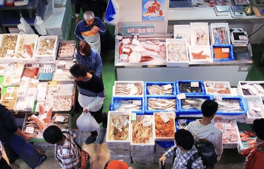 A seafood market with various fish displayed in trays. 3