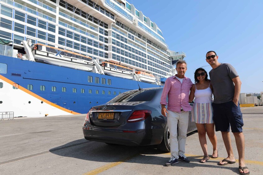 A cruise ship docked with a car parked in front. 5