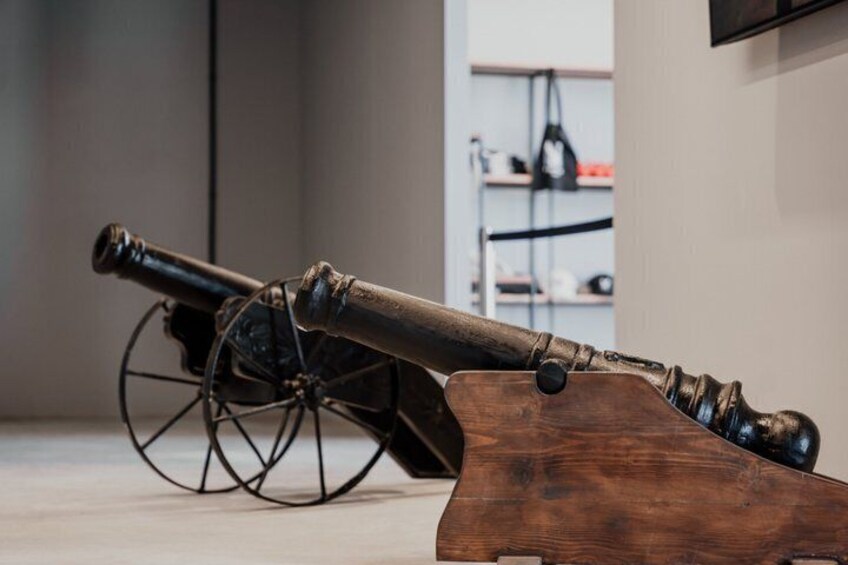 An antique cannon on a wooden stand. 4