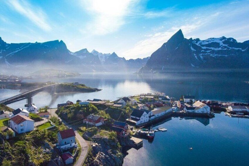 A fjord with a small village, a bridge, and mountains in the background. 5