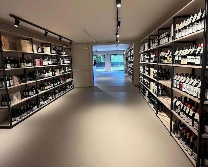 A modern wine cellar with shelves stocked with bottles and boxes. 4