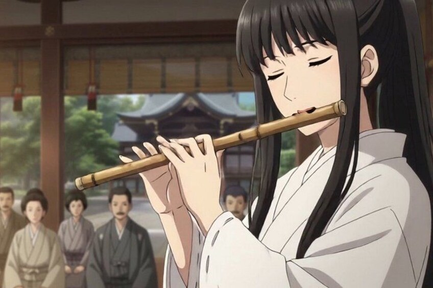 A person playing a flute in a traditional setting with a group of people in the background. 2