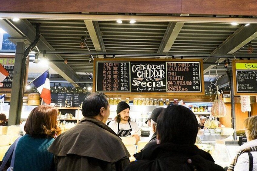 A food market with a menu board displaying various dishes. 3