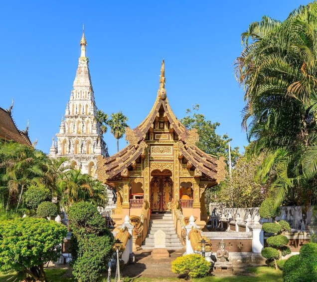 A temple with intricate architecture and a large spire, surrounded by lush greenery. 5