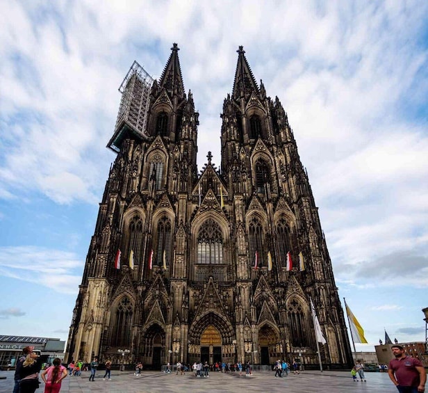 A Gothic cathedral with intricate architecture and multiple flags. 3