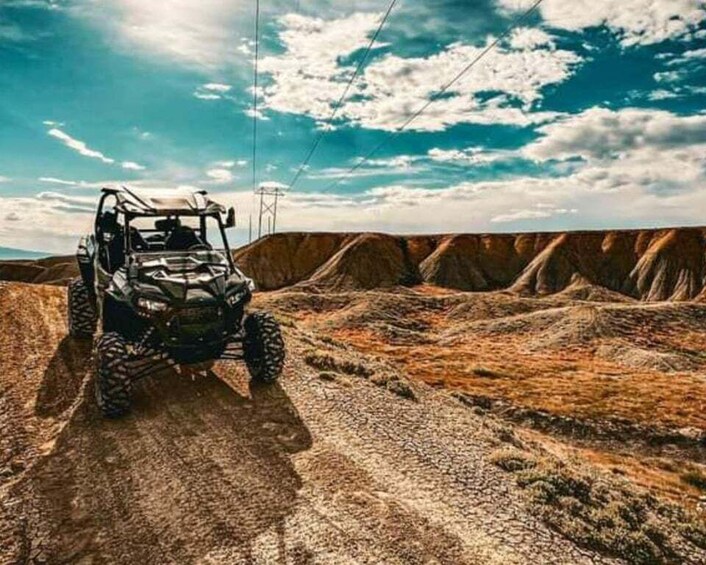 A quad bike on a rocky terrain with a clear sky. 2