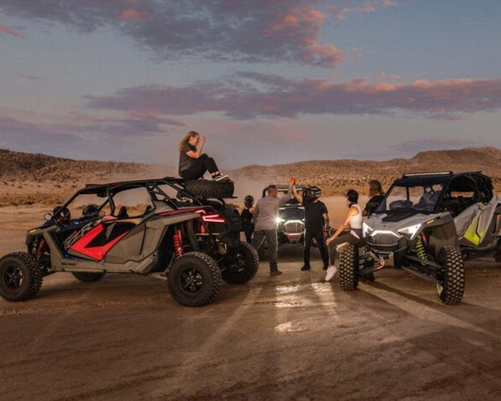 Off-road vehicles parked in a desert setting with a clear sky. 3