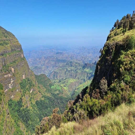 A mountainous landscape with steep cliffs and a valley below. 3