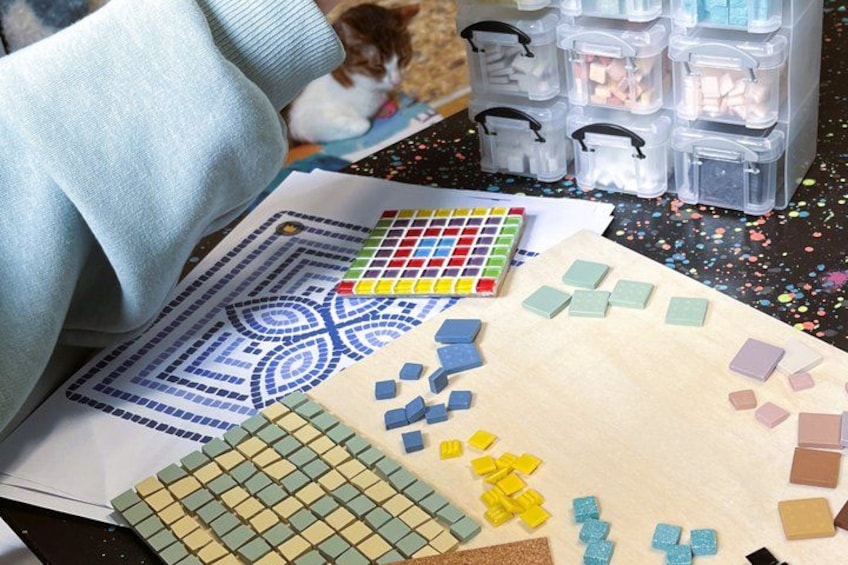 A crafting table with a pattern, colored tiles, and a storage box. 2