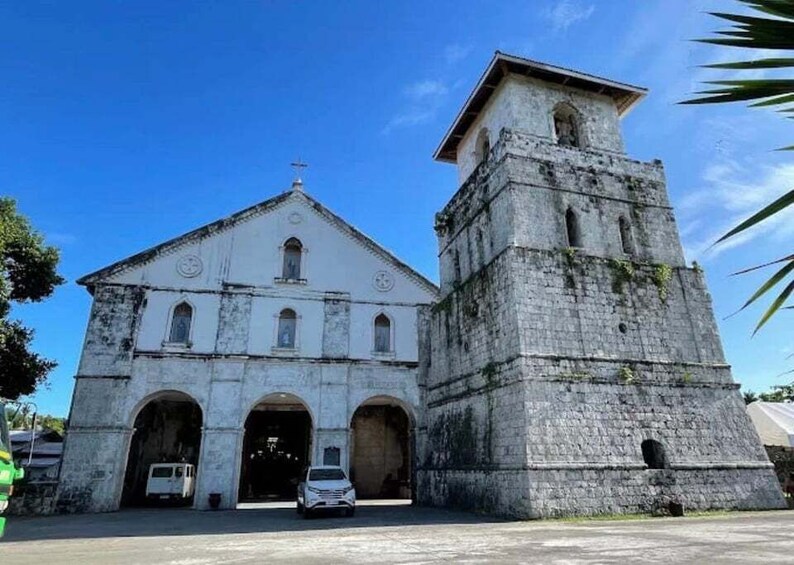 A historic church with a bell tower and arched entrances. 3