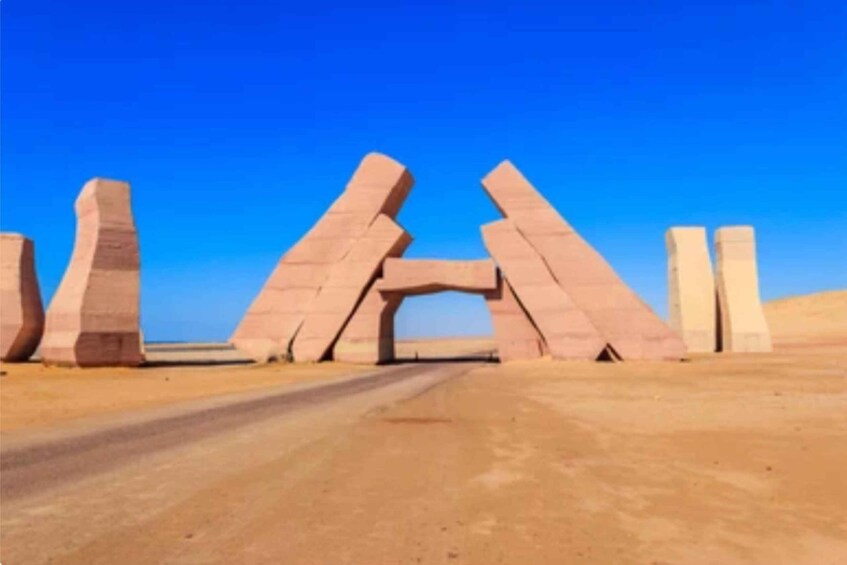 A desert road with large, upright stone structures. 4