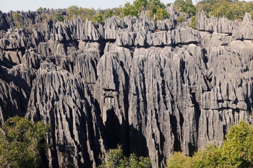 A rugged, rocky landscape with towering limestone formations. 4