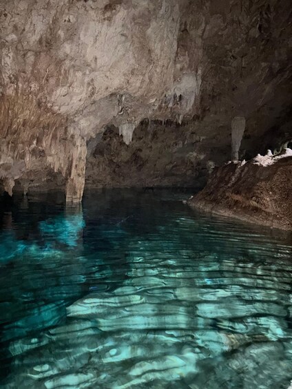 A cave with clear water reflecting the rocky ceiling. 2