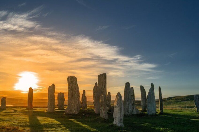 Stonehenge at sunset with the sun low on the horizon. 1