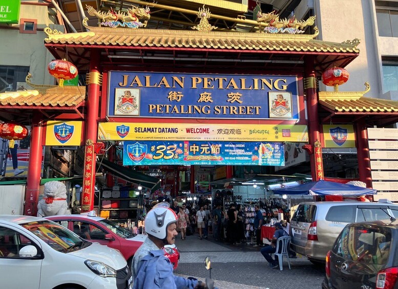 JALAN PETALING STREET with traditional Chinese architecture, a signboard, and a bustling street scene. 1