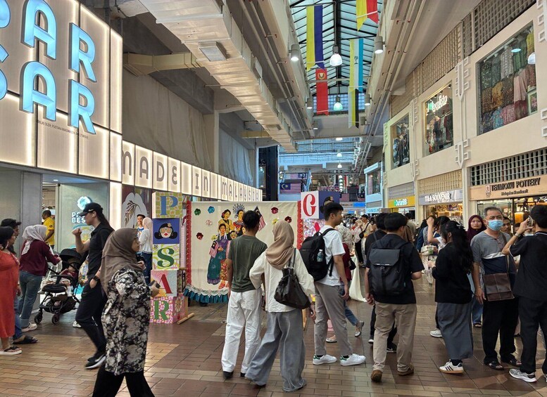 A busy indoor shopping mall with various stores and a crowd of people. 4