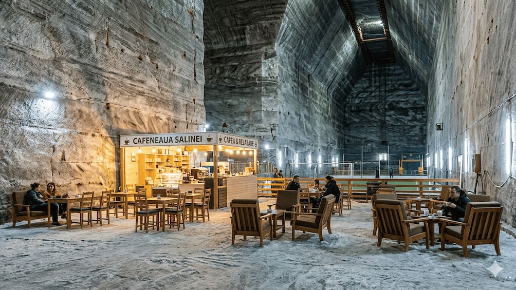 An indoor cafe with wooden furniture and a stone interior. 3