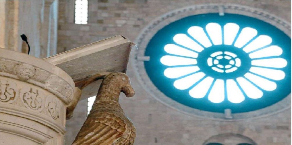 A classical column with a carved horse head and a blue circular skylight. 3