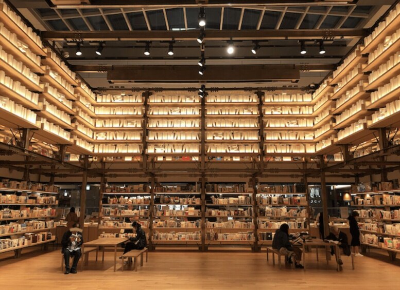 A large, well-lit library with multiple levels of bookshelves and patrons reading. 4