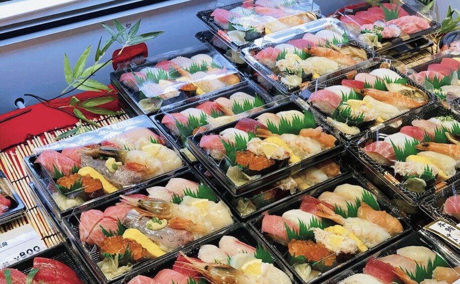 A variety of sushi displayed in trays. 5