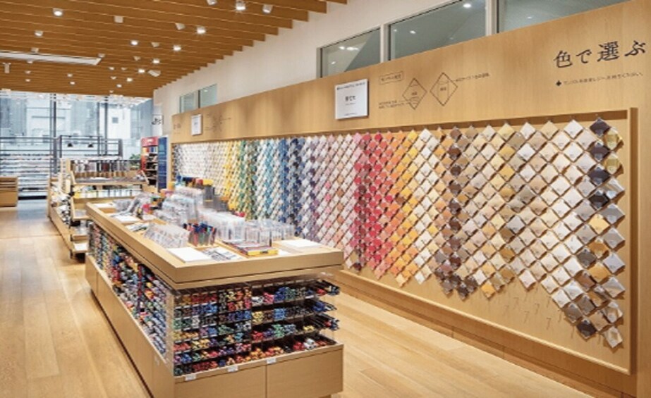 A jewelry store with a wall display of various colored gemstones and a counter with jewelry boxes. 2