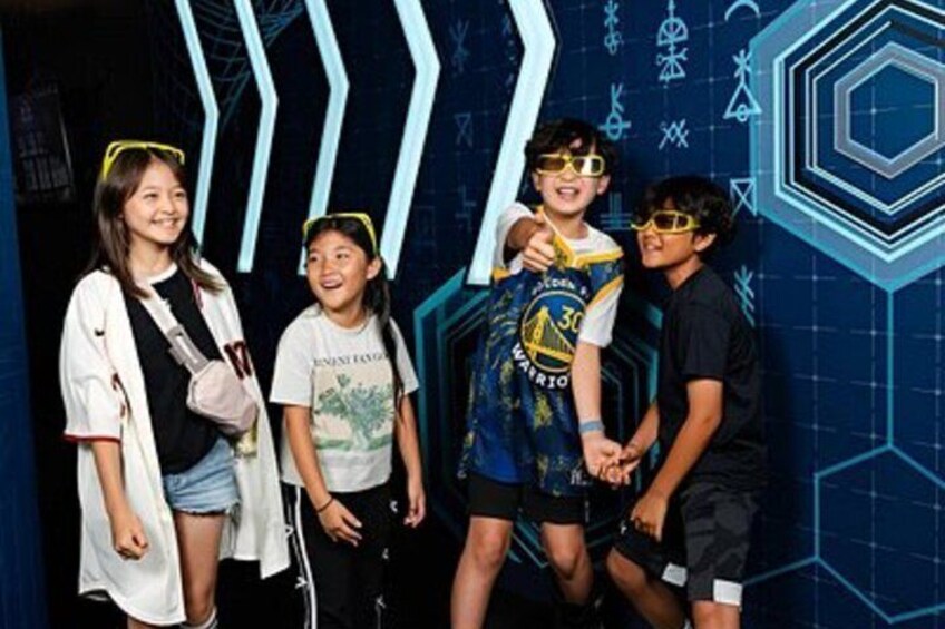 A group of people in a themed setting with geometric patterns and hexagonal shapes. 2