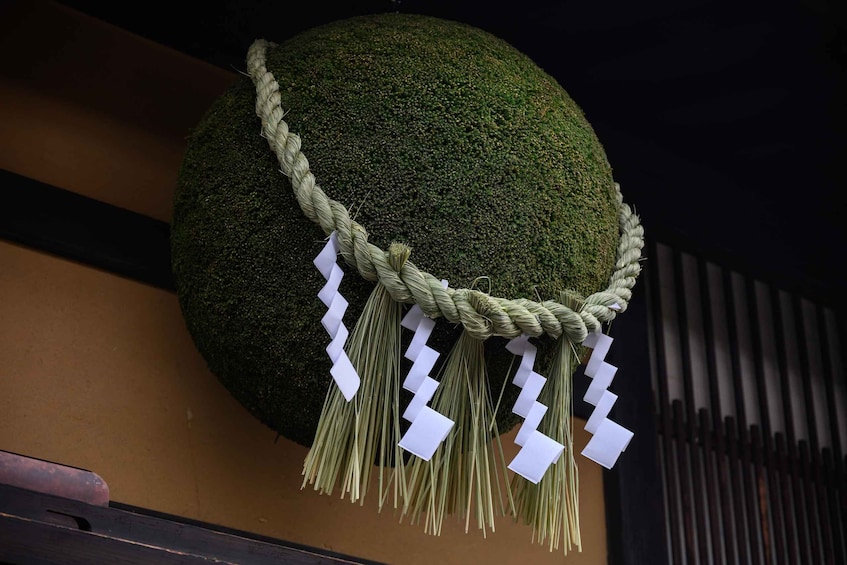 A spherical object with a rope and white zigzag decorations. 2