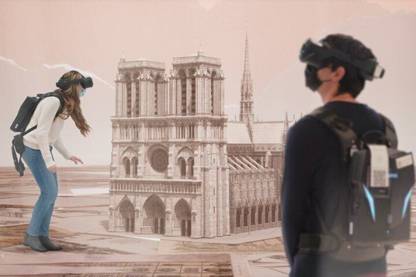 A person in a virtual reality headset standing in front of a detailed architectural model of a cathedral. 2