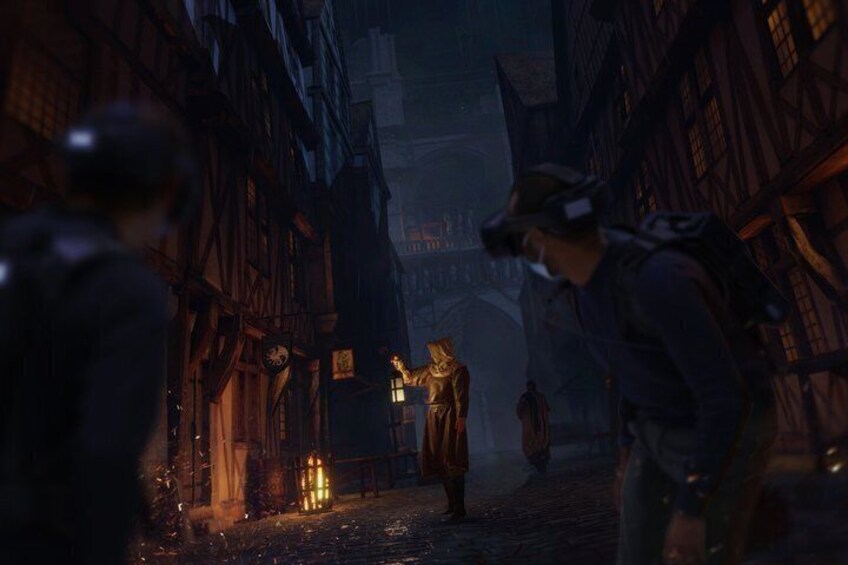 A medieval street scene with buildings, a statue, and a person in a hooded cloak. 3